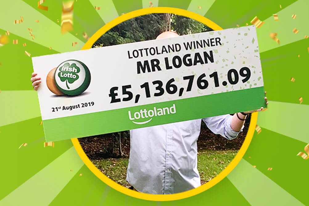 Mr Logan holds up Irish Lotto winner's cheque for over £5 million