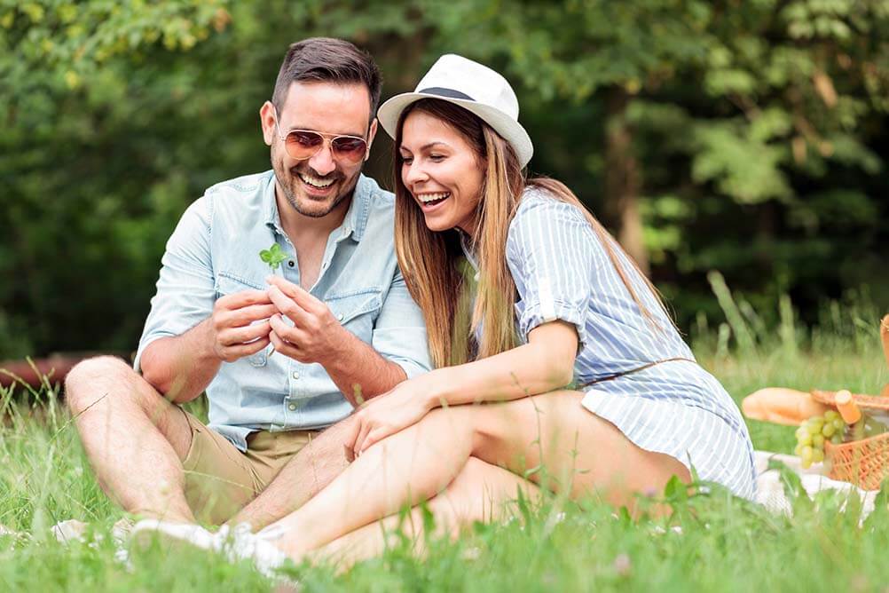 Couple in field find four leaf clover