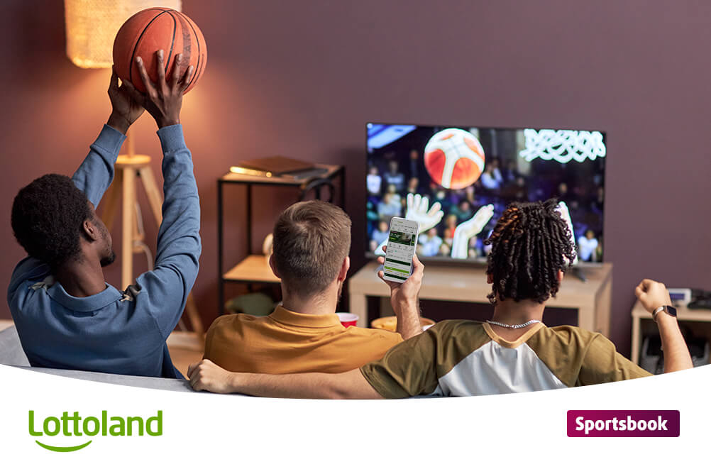 Group of men betting on NBA at Lottoland on mobile phone watching basketball on TV